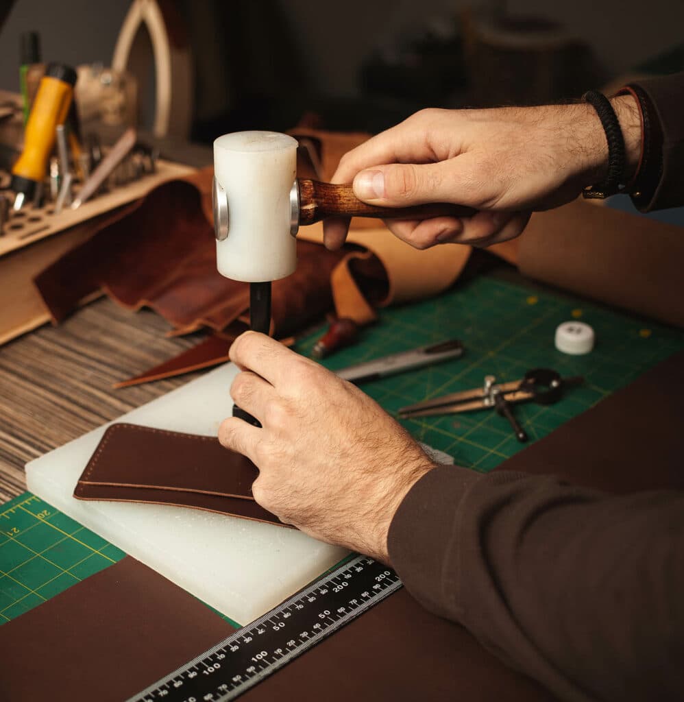 Tanner making leather bag